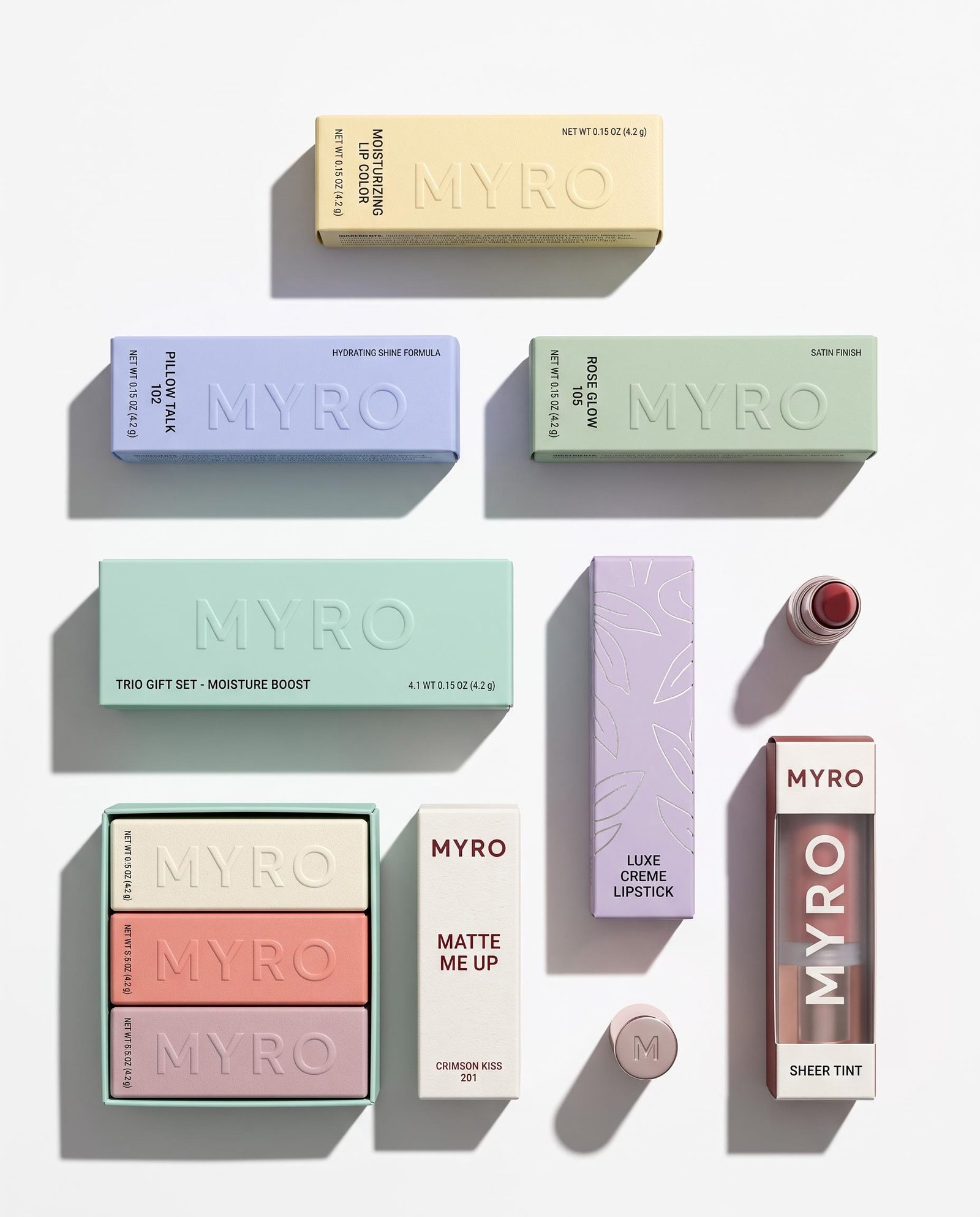 Pastel cosmetic packaging and coordinated product containers arranged as a flat-lay collection.
