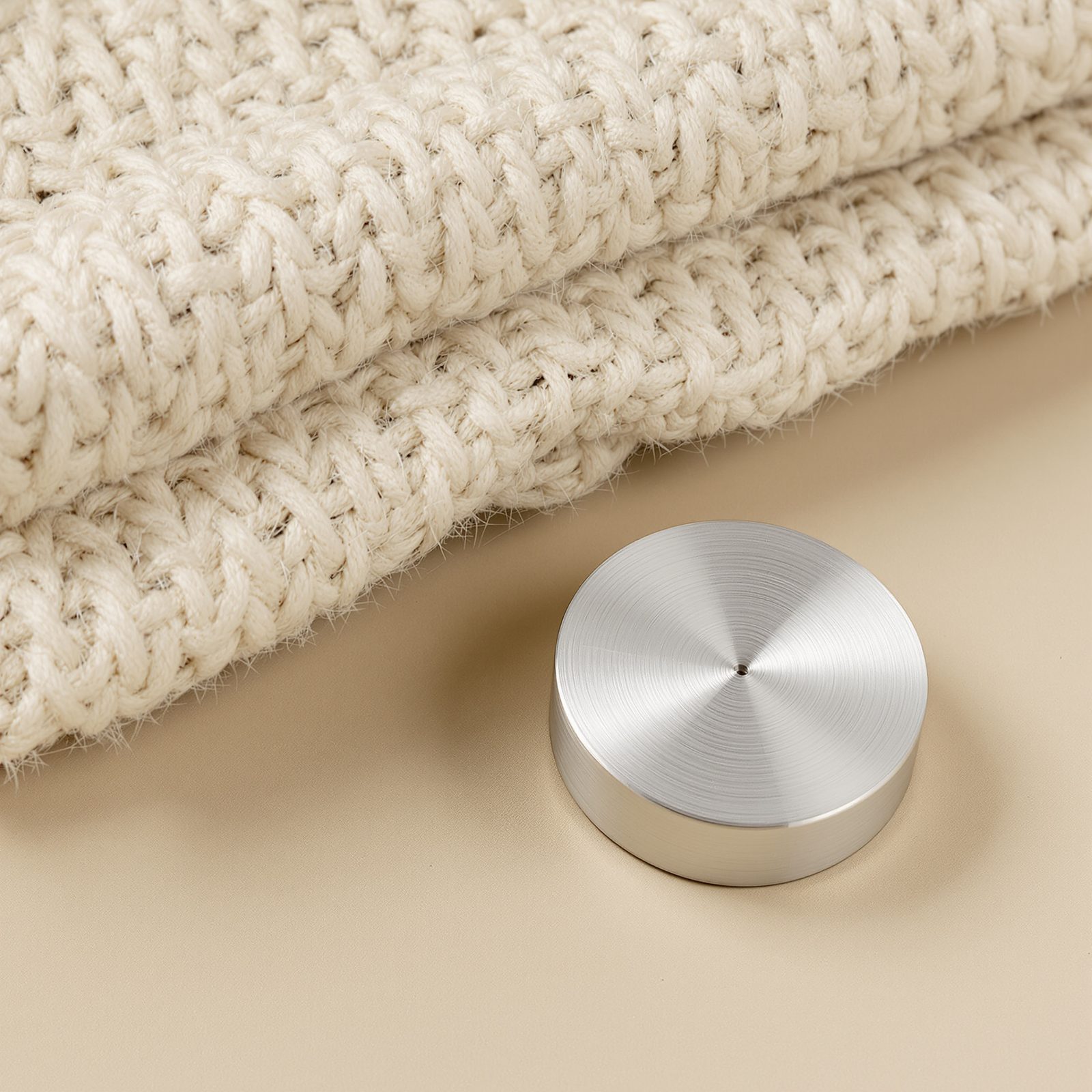 Close material study of cream woven wool and a brushed titanium component, generated at 2048 by 2048 pixels.
