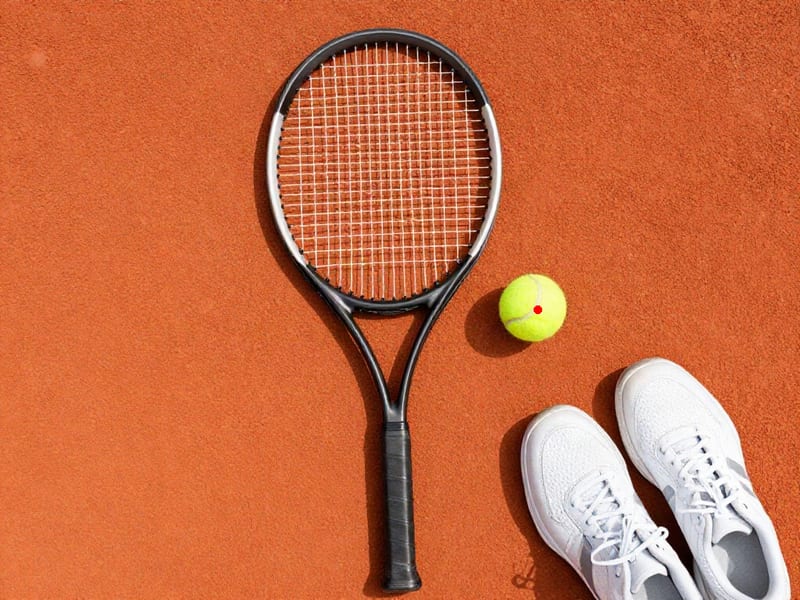 Moondream Detection point marker identifying a yellow tennis ball on a clay court.