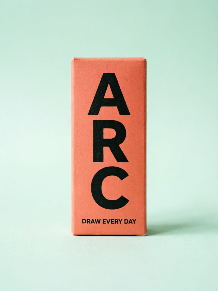 Coral pencil box with bold ARC lettering on a mint background.