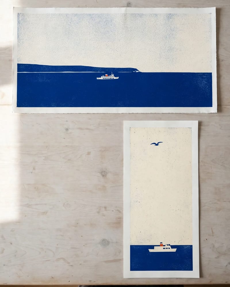 Two ferry screenprints laid on a pale ash plan chest: one wide panoramic 21:9 print and one tall narrow 9:21 print