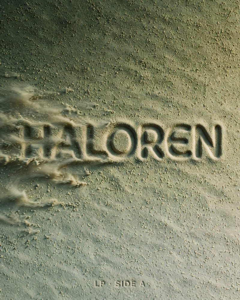 Album cover: the word HALOREN blind-embossed into moss-green sand texture, smearing like wind-blown sand, with LP · SIDE A debossed below